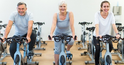 Individuals riding on Spin bikes